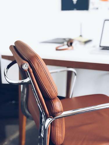 office closeup photography of brown leather chair near white table greenville